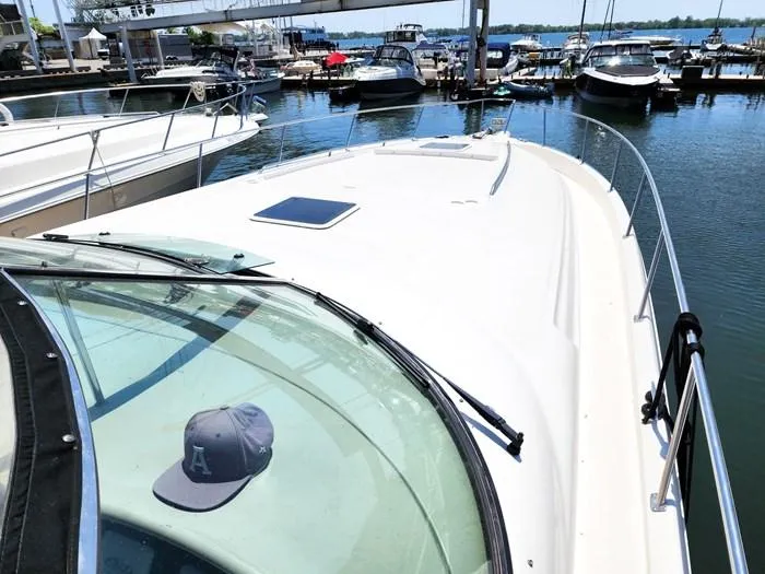  Yacht Photos Pics 1999 Sea Ray 460 Sundancer yacht docked at marina, sunny day, cap on windshield.