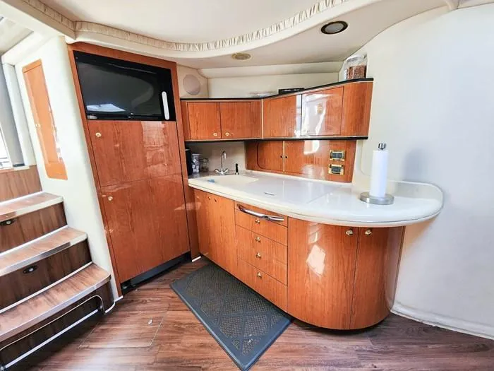  Yacht Photos Pics Interior of 1999 Sea Ray 460 Sundancer yacht with wooden cabinetry and modern amenities.