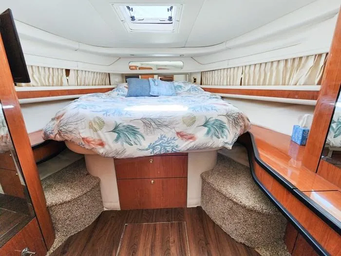  Yacht Photos Pics 1999 Sea Ray 460 Sundancer cabin with bed, wood accents, and skylight.