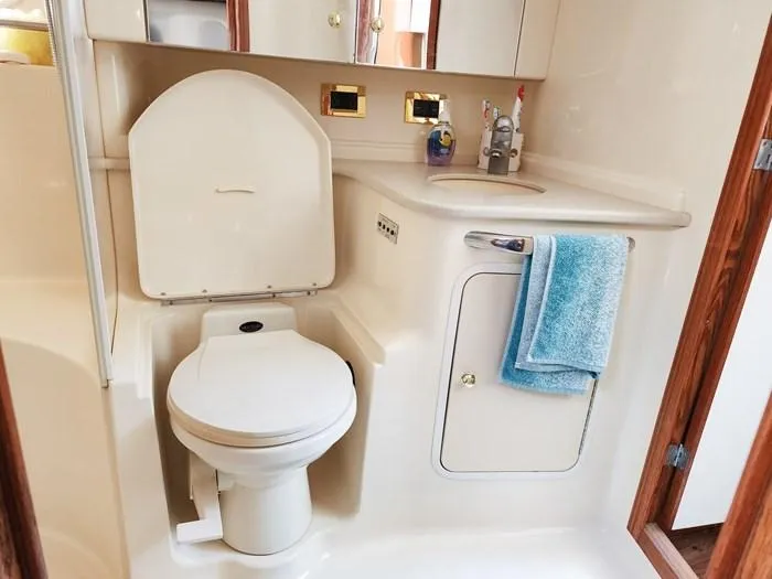  Yacht Photos Pics Bathroom interior of 1999 Sea Ray 460 Sundancer yacht, featuring toilet and sink.