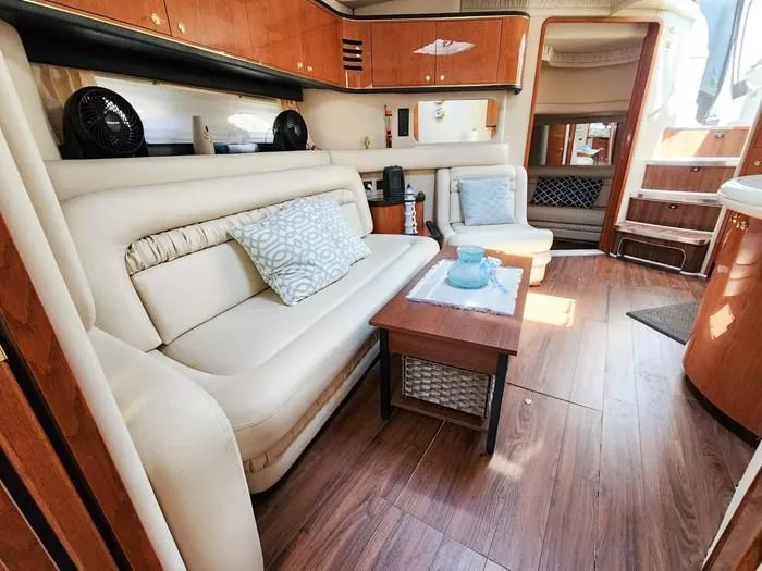  Yacht Photos Pics Luxurious interior of 1999 Sea Ray 460 Sundancer yacht with plush seating and elegant wood finishes.