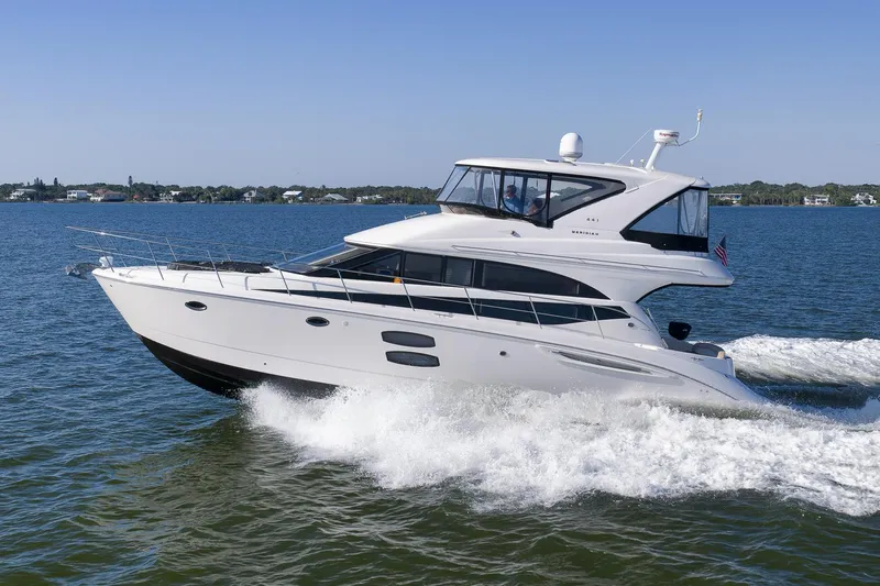  Yacht Photos Pics 2012 Meridian 441 Sedan yacht cruising on open water, clear blue sky.