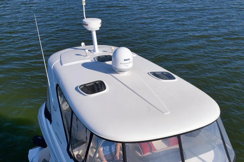  Yacht Photos Pics 2012 Meridian 441 Sedan yacht on water, featuring sleek white design and advanced navigation equipment.