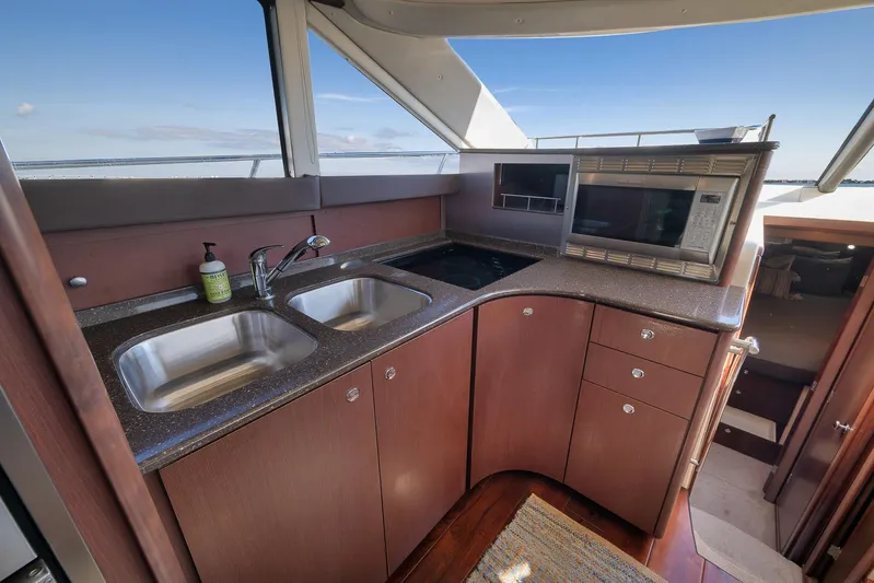  Yacht Photos Pics Luxurious kitchen area in a 2012 Meridian 441 Sedan yacht with dual sinks and microwave.