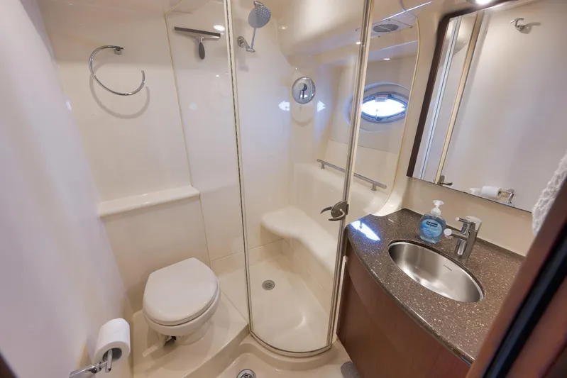  Yacht Photos Pics Luxurious bathroom in 2012 Meridian 441 Sedan yacht with shower, toilet, and sink.
