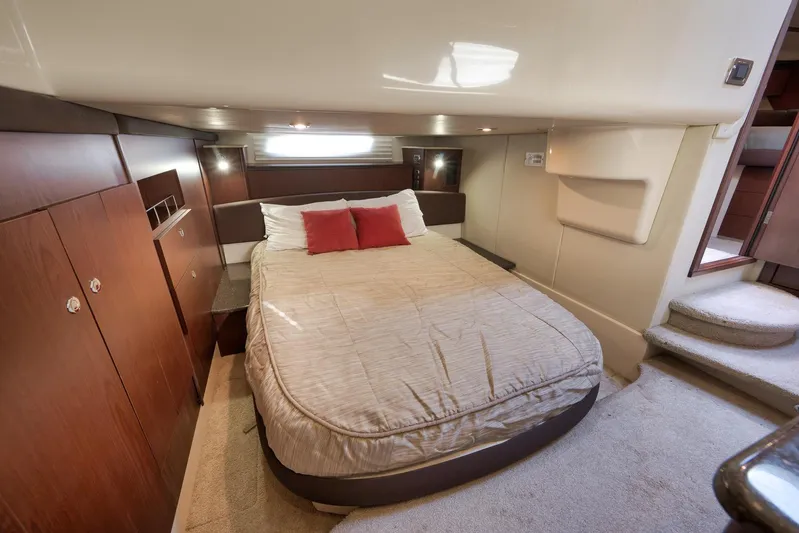  Yacht Photos Pics Luxurious bedroom interior of 2012 Meridian 441 Sedan yacht with cozy bed and wooden accents.
