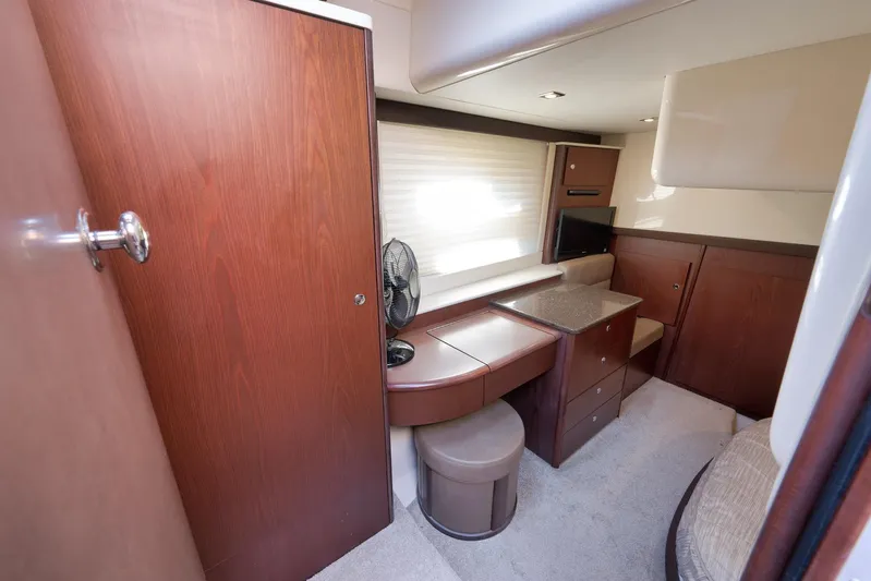  Yacht Photos Pics 2012 Meridian 441 Sedan interior with wood cabinetry, seating, and a small TV.