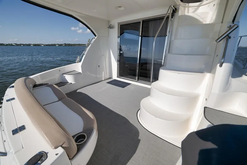  Yacht Photos Pics 2012 Meridian 441 Sedan yacht interior with seating and stairs, overlooking calm waters.