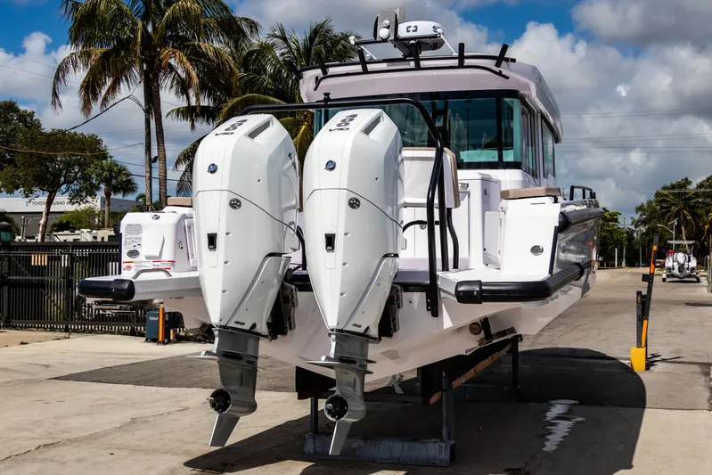  Yacht Photos Pics 2025 Axopar 37XC CROSS CABIN BRABUS Trim with dual engines, docked outdoors.