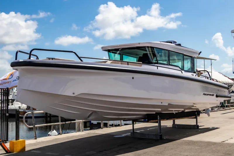  Yacht Photos Pics 2025 Axopar 37XC CROSS CABIN BRABUS Trim boat docked under a clear blue sky.