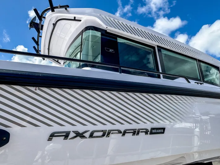  Yacht Photos Pics 2025 Axopar 37XC CROSS CABIN BRABUS Trim boat under a blue sky.
