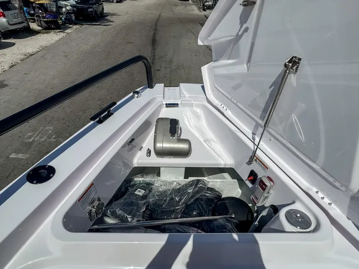  Yacht Photos Pics 2025 Axopar 37XC CROSS CABIN BRABUS Trim storage compartment, open lid, showcasing interior features.