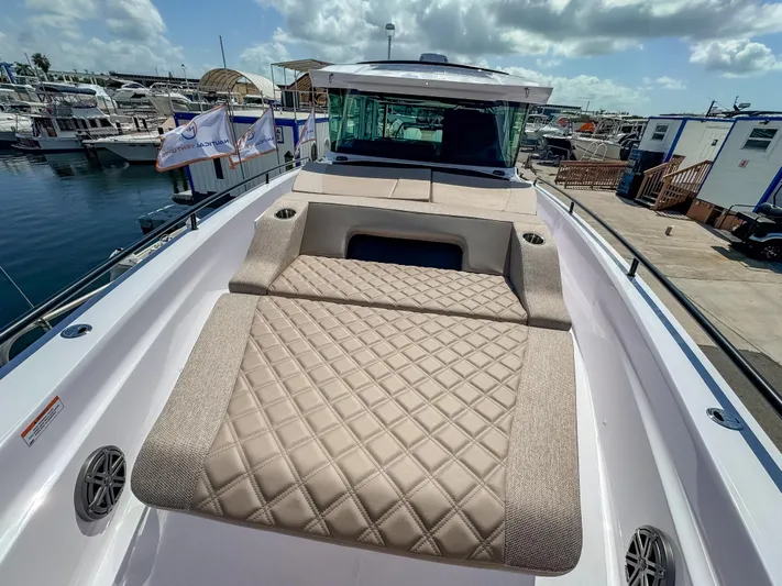  Yacht Photos Pics 2025 Axopar 37XC CROSS CABIN BRABUS Trim with luxurious sunbed, docked at marina.