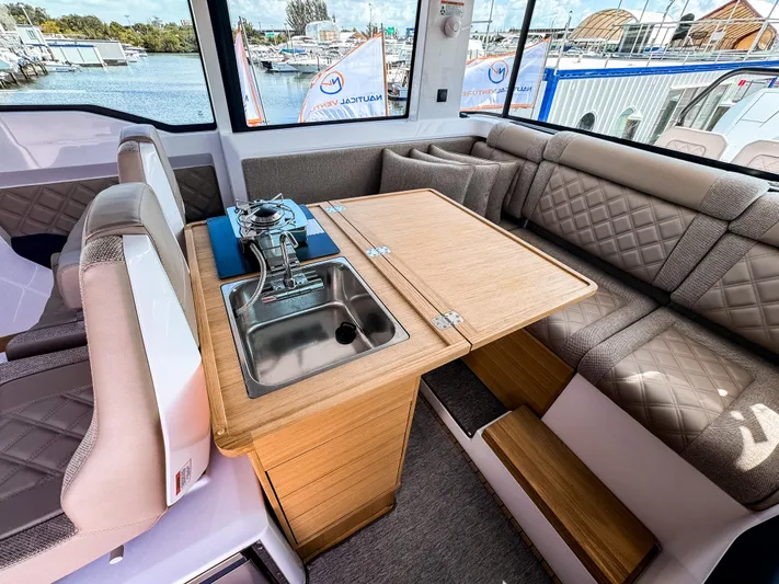  Yacht Photos Pics 2025 Axopar 37XC CROSS CABIN BRABUS interior with sink and seating area.