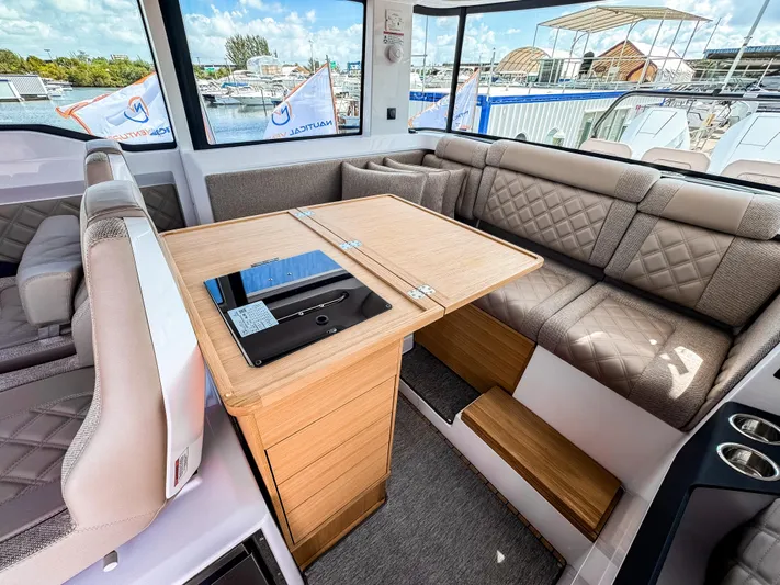  Yacht Photos Pics Interior of 2025 Axopar 37XC CROSS CABIN BRABUS Trim with luxurious seating and table.