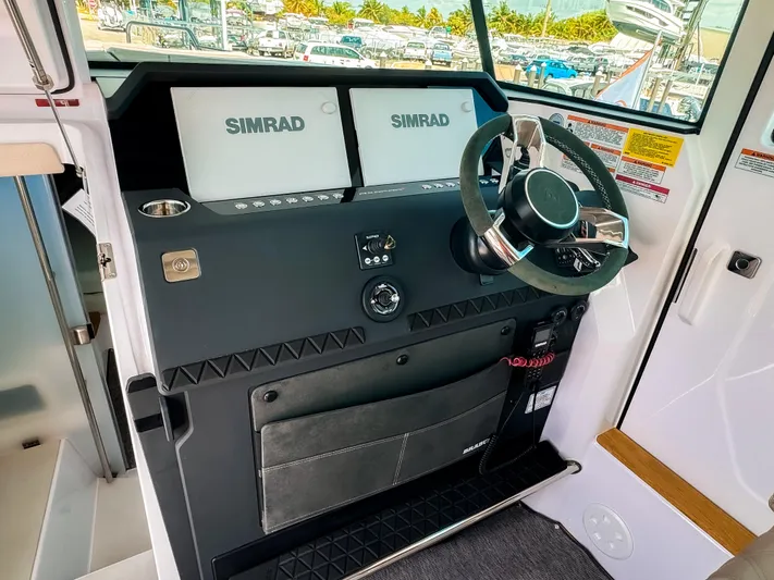  Yacht Photos Pics 2025 Axopar 37XC CROSS CABIN BRABUS helm with dual Simrad displays and sleek steering wheel.