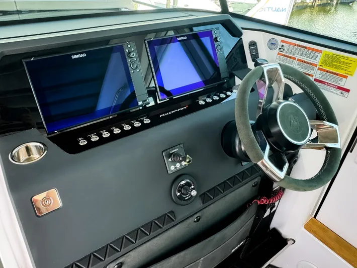  Yacht Photos Pics 2025 Axopar 37XC CROSS CABIN BRABUS Trim dashboard with dual Simrad displays and steering wheel.