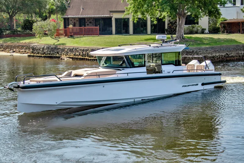  Yacht Photos Pics 2025 Axopar 37XC CROSS CABIN BRABUS Trim cruising on a calm river.