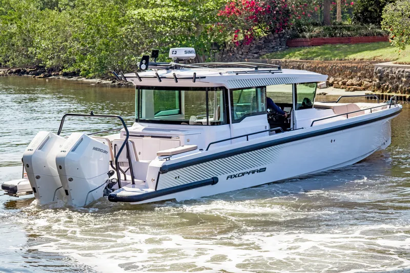  Yacht Photos Pics 2025 Axopar 37XC CROSS CABIN BRABUS Trim boat cruising on a scenic waterway.