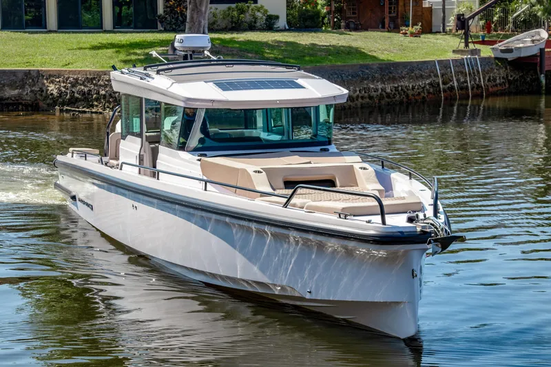  Yacht Photos Pics 2025 Axopar 37XC CROSS CABIN BRABUS Trim cruising on a calm river.