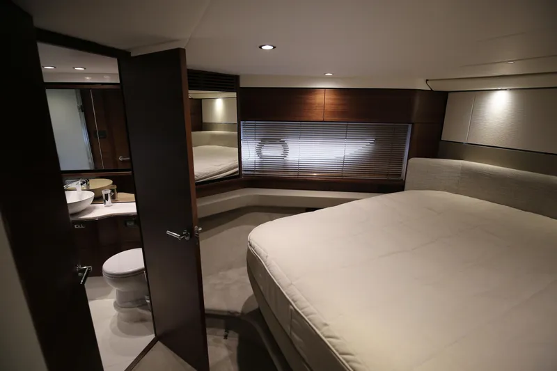  Yacht Photos Pics Luxurious interior of 2025 Princess F55 yacht with modern bedroom and ensuite bathroom.