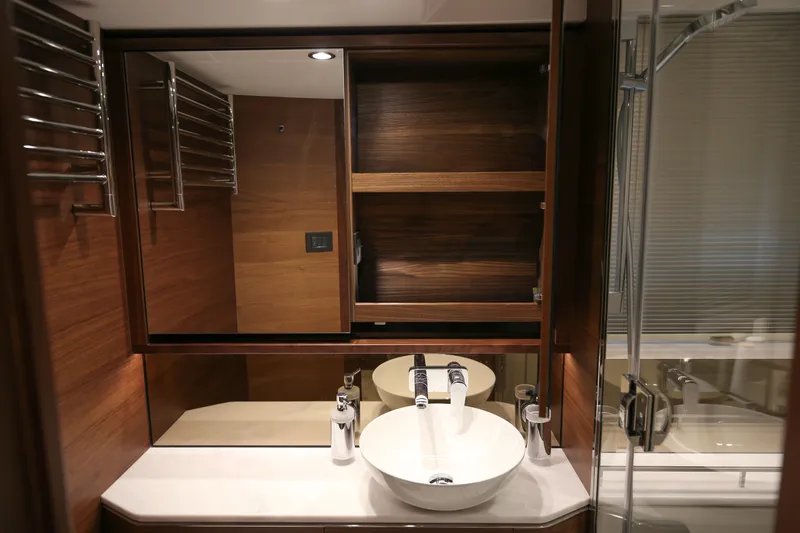  Yacht Photos Pics Luxurious bathroom in 2025 Princess F55 yacht with modern fixtures and wooden accents.