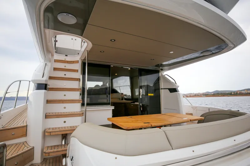  Yacht Photos Pics Luxury yacht Princess F55 2025 model, featuring elegant outdoor seating and staircase.