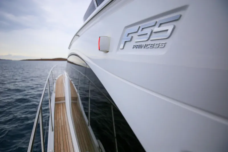  Yacht Photos Pics 2025 Princess F55 yacht on water, showcasing sleek design and branding.