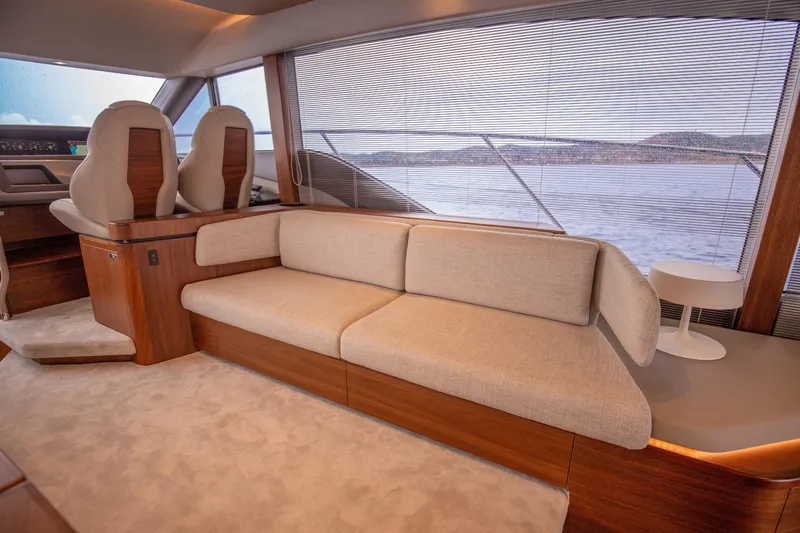  Yacht Photos Pics Luxurious interior of 2025 Princess F55 yacht with elegant seating and scenic window view.
