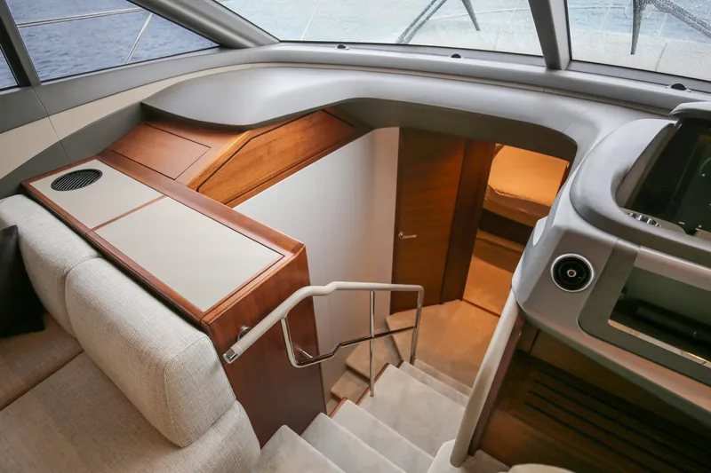  Yacht Photos Pics Luxurious interior of 2025 Princess F55 yacht with modern staircase and elegant wood finishes.