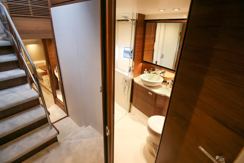  Yacht Photos Pics Luxurious interior of 2025 Princess F55 yacht featuring elegant bathroom and staircase.