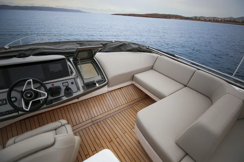  Yacht Photos Pics Luxurious 2025 Princess F55 yacht interior with sleek helm and spacious seating area.
