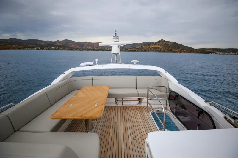 Yacht Photos Pics Luxurious 2025 Princess F55 yacht deck with seating and table, overlooking serene waters.