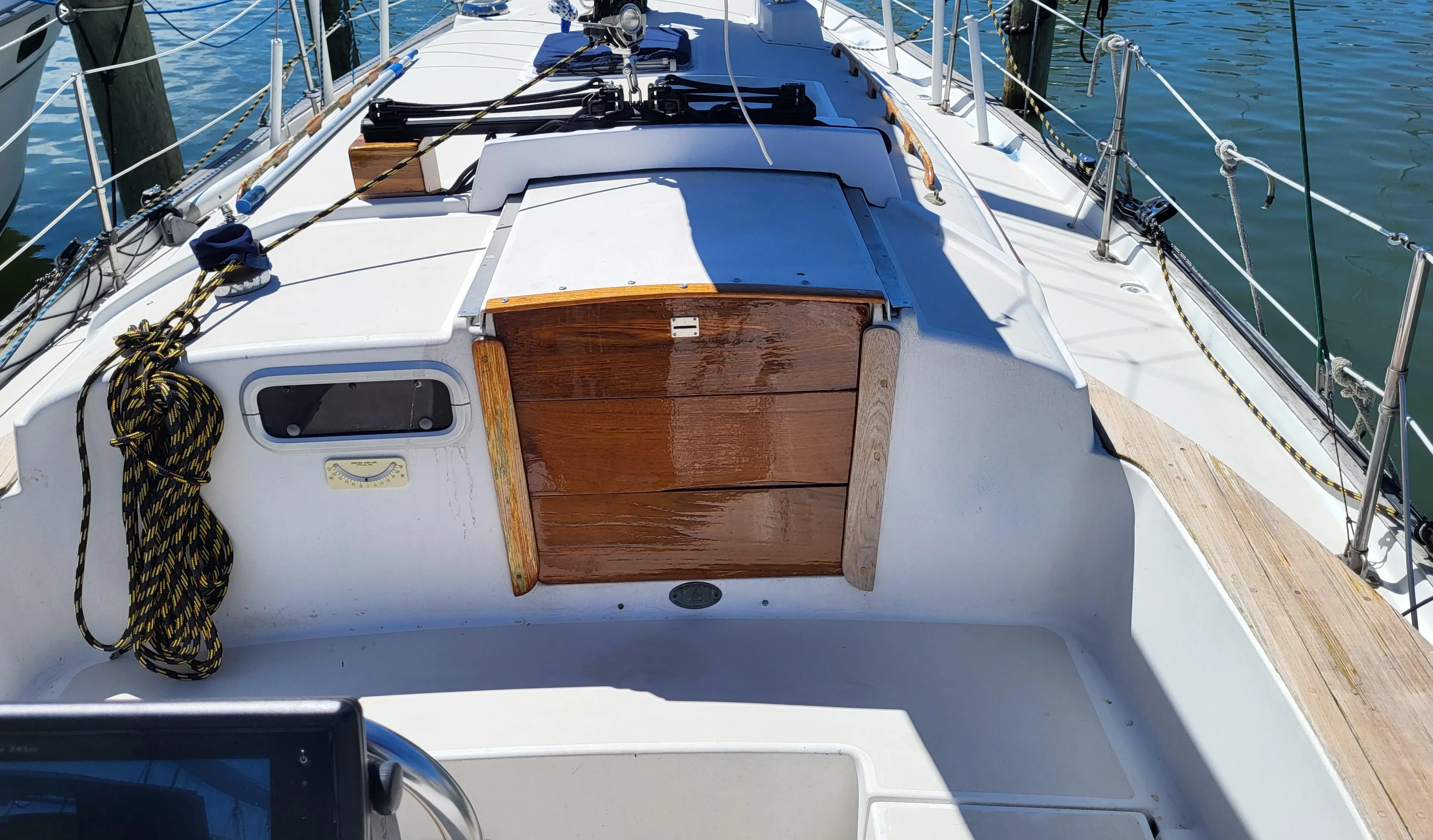 1979 Pearson 365 Sloop sailboat deck with wooden hatch and ropes.