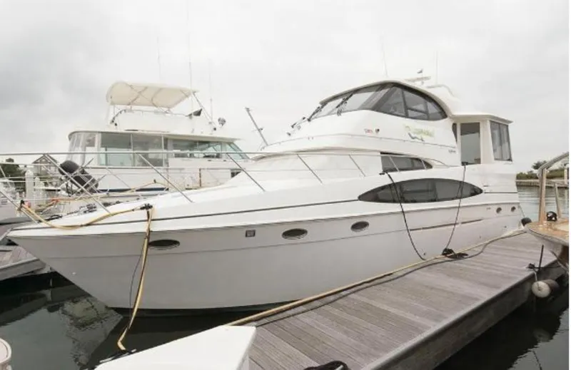  Yacht Photos Pics 2000 Carver 506 Motor Yacht docked at marina, showcasing sleek design and spacious deck.