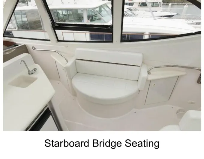  Yacht Photos Pics Starboard bridge seating on 2000 Carver 506 Motor Yacht, featuring white cushioned bench.