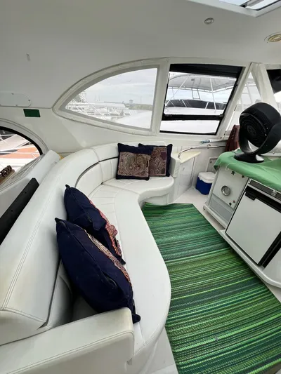  Yacht Photos Pics Interior of 2000 Carver 506 Motor Yacht with white seating and green rug.