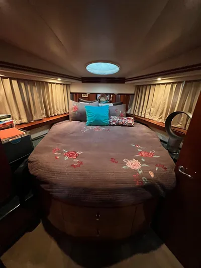  Yacht Photos Pics Luxurious bedroom in 2000 Carver 506 Motor Yacht with floral bedding and ambient lighting.