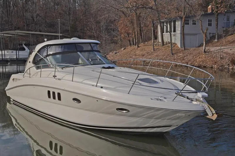  Yacht Photos Pics 2008 Sea Ray 38 Sundancer yacht docked on a calm lake with wooded shoreline.