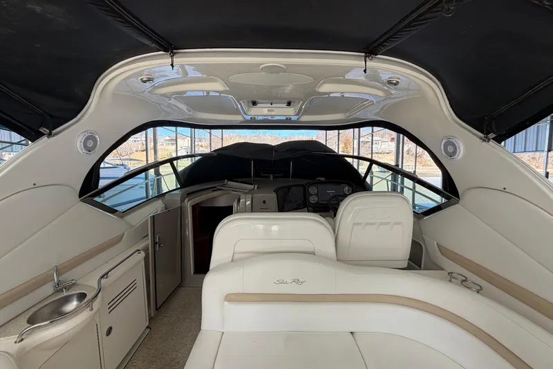  Yacht Photos Pics 2008 Sea Ray 38 Sundancer interior with seating, helm, and kitchenette under black canopy.