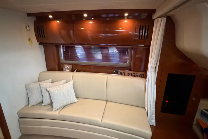  Yacht Photos Pics Interior of 2008 Sea Ray 38 Sundancer with beige sofa and wooden cabinetry.