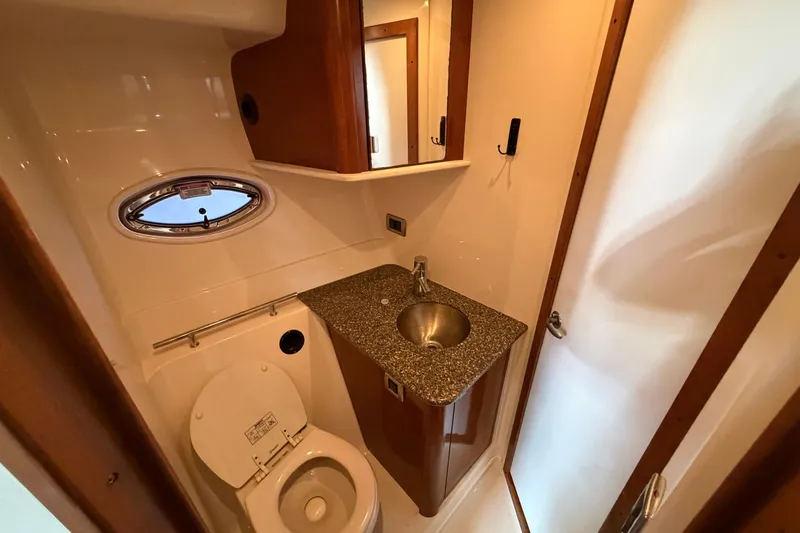  Yacht Photos Pics 2008 Sea Ray 38 Sundancer bathroom with toilet, sink, and porthole window.