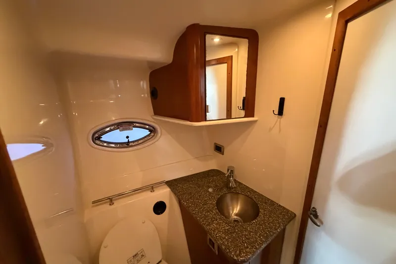  Yacht Photos Pics Luxurious bathroom in 2008 Sea Ray 38 Sundancer yacht with sink and porthole window.