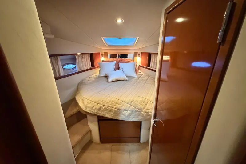  Yacht Photos Pics Luxurious cabin interior of 2008 Sea Ray 38 Sundancer yacht with cozy bed and ambient lighting.