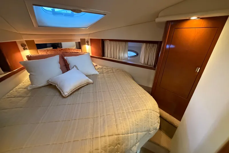  Yacht Photos Pics Luxurious cabin interior of 2008 Sea Ray 38 Sundancer with cozy bedding and ambient lighting.