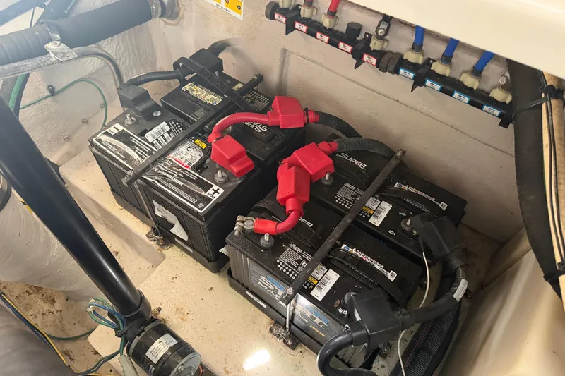  Yacht Photos Pics Battery compartment of a 2008 Sea Ray 38 Sundancer boat, showing multiple batteries and wiring.