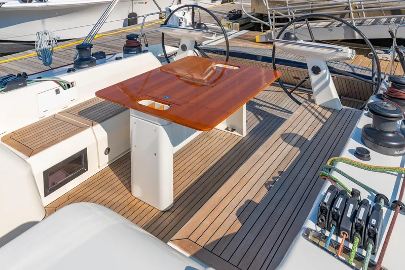 Nehalennia Yacht Photos Pics 2018 Nautor Swan 54 yacht deck with dual steering wheels and wooden table.
