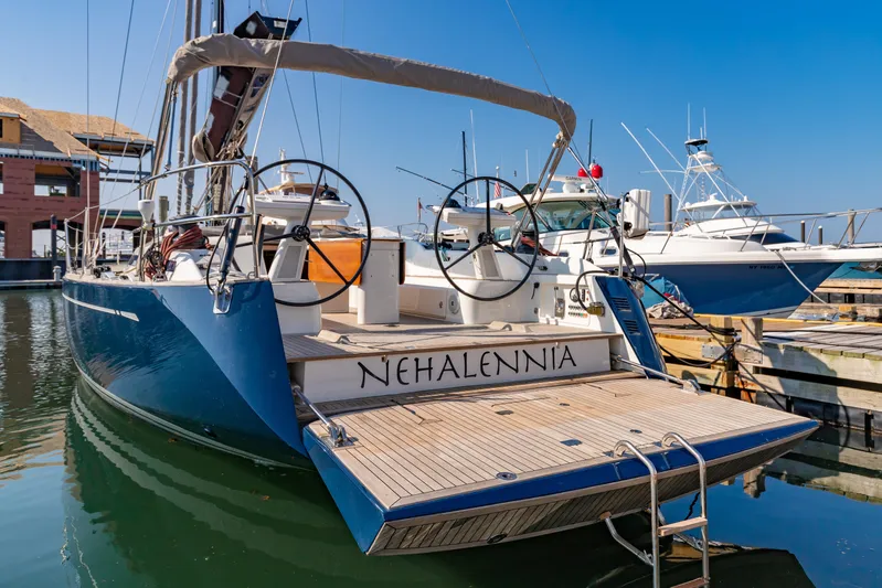 Nehalennia Yacht Photos Pics 2018 Nautor Swan 54 yacht docked at marina, featuring dual steering wheels.