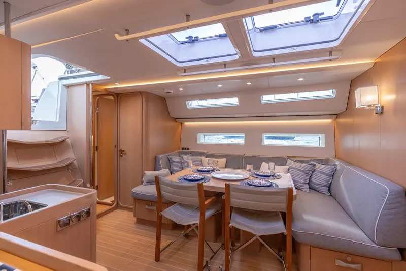 Nehalennia Yacht Photos Pics Luxurious interior of 2018 Nautor Swan 54 yacht with elegant dining area and skylights.