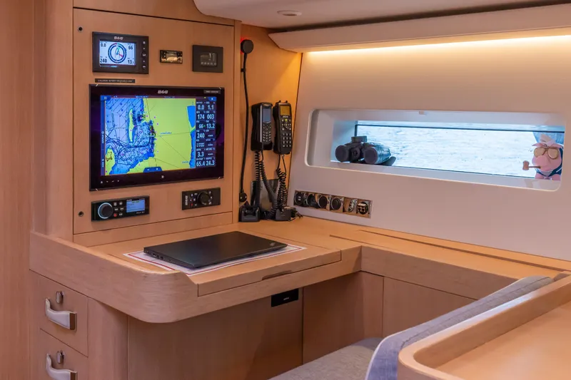 Nehalennia Yacht Photos Pics Navigation station of 2018 Nautor Swan 54 yacht with electronic equipment and window view.